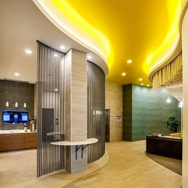 A commercial space with bright yellow curved lighting on the ceiling.