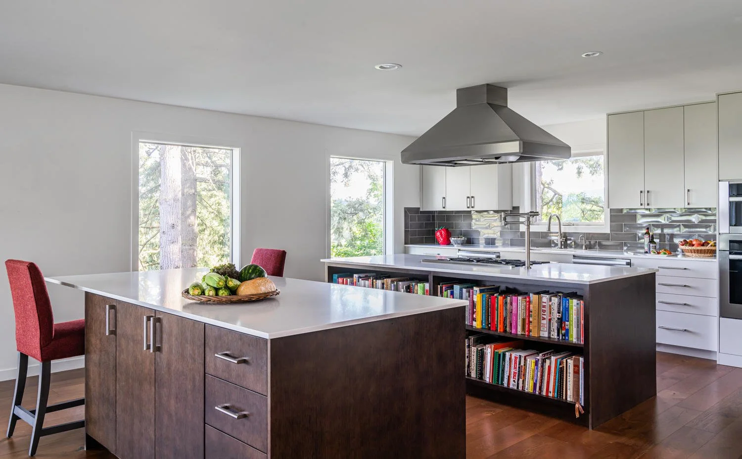 A kitchen with multiple islands and storage.