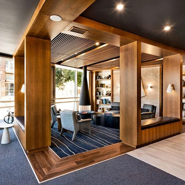 An amenity area with wood paneling and a fireplace.