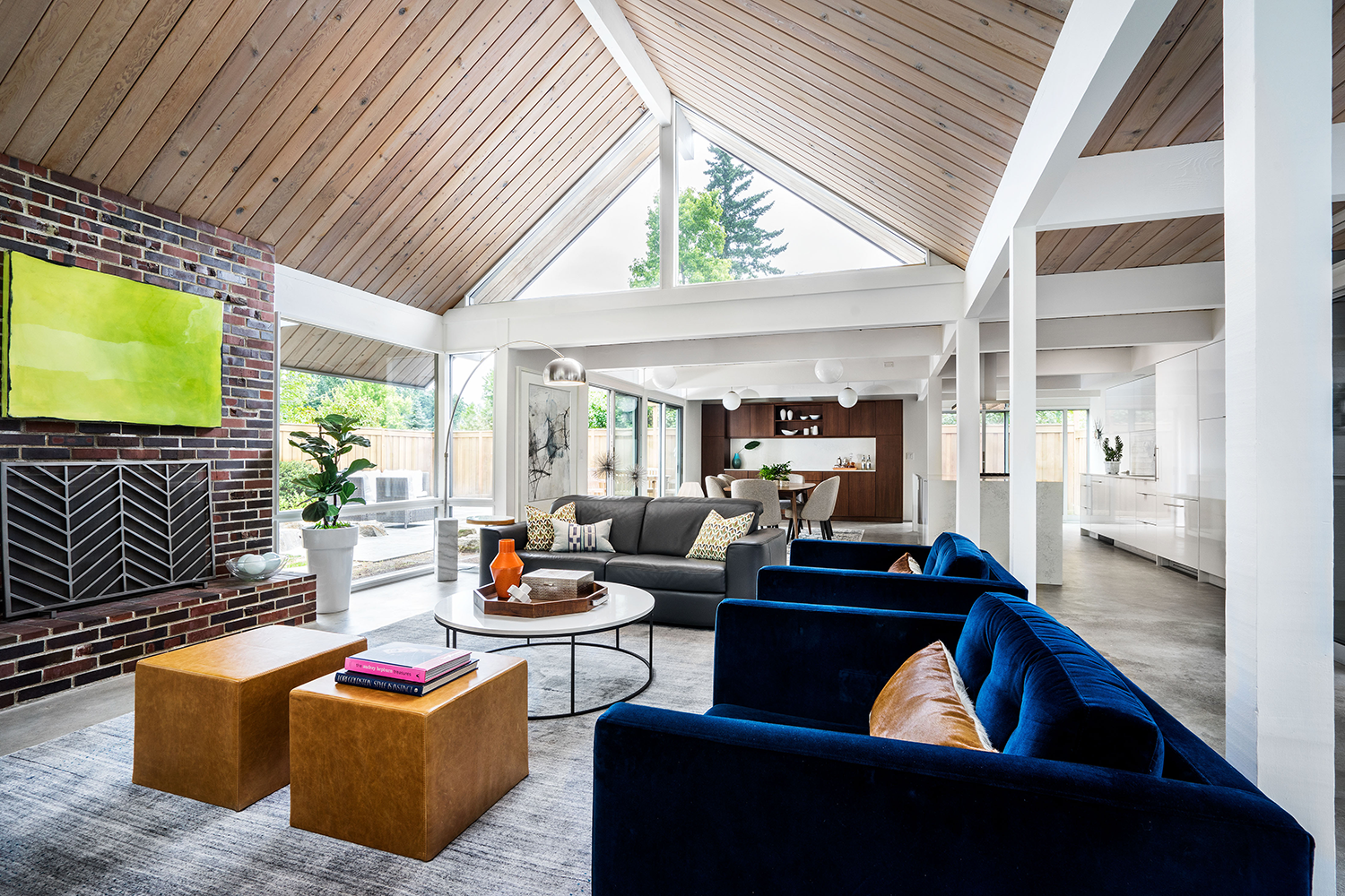 Living room of a classic Rummer house looking toward new dining room built-ins, with navy blue velvet chairs, Beaverton OR interior design by Studio Garrison.