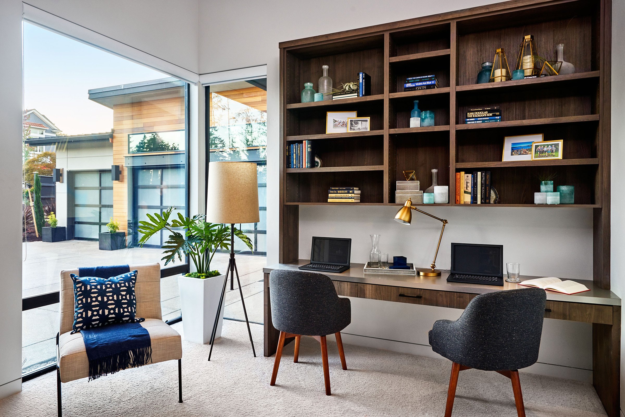 A home office with large windows.