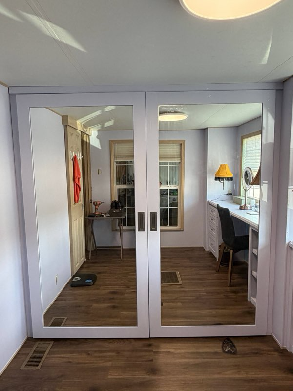 Full Length handmade mirrored doors close off this modern closet retrofit. 