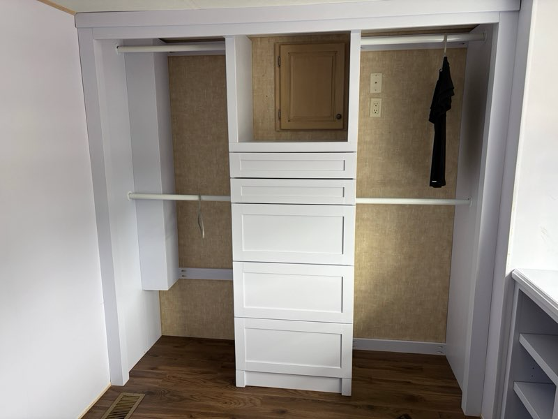 Modern Closet Build-out with 5 Drawer Tower and plenty of hanging space for Two. 