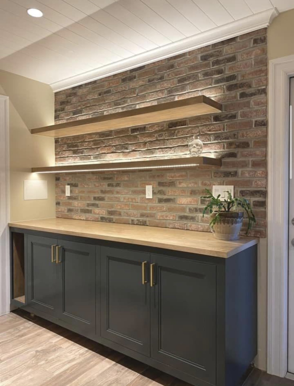 Bar area with floating shelves w/ lighting elements 