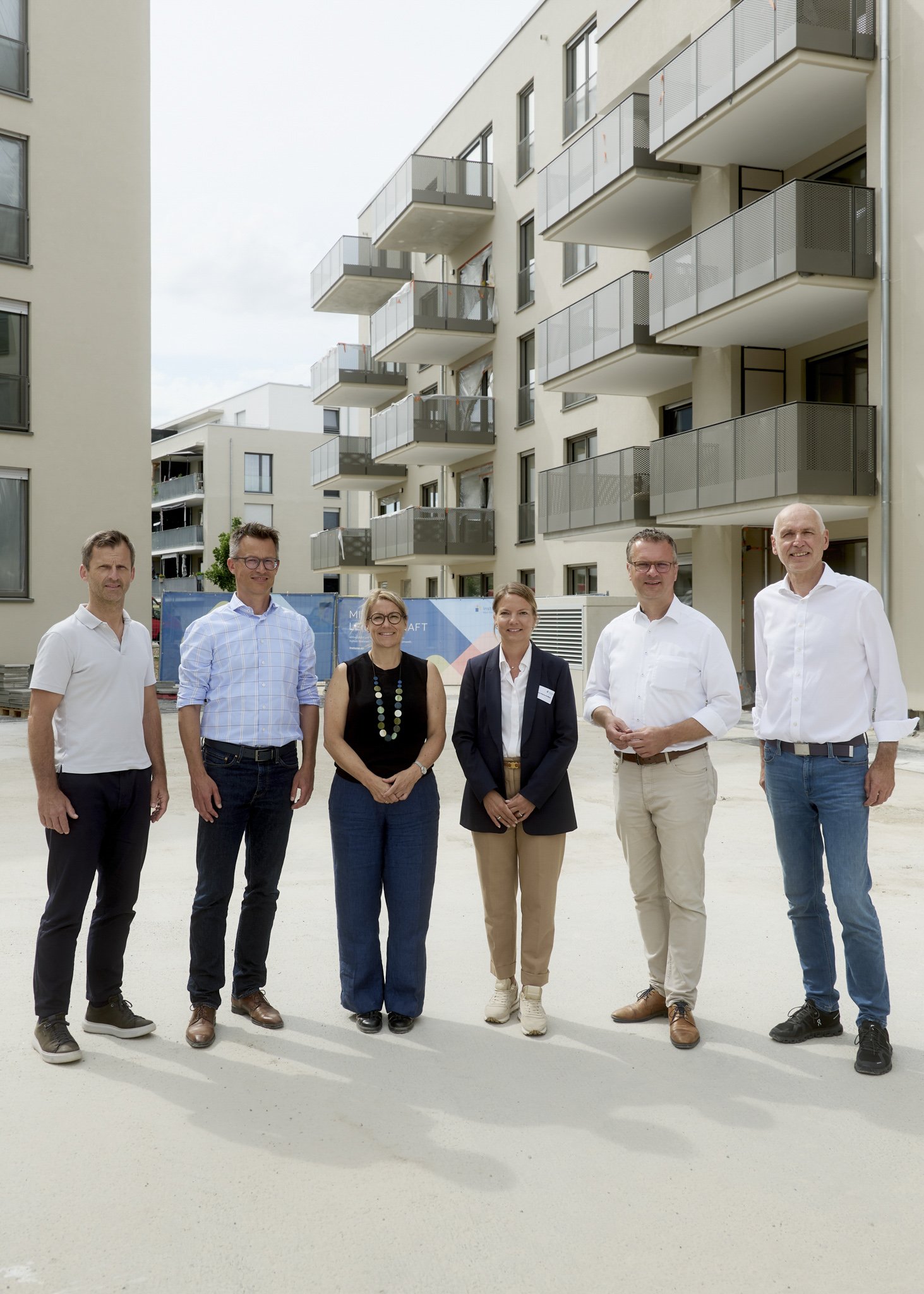 Projektteam als Gruppenfoto vor Neubau, Termin auf Baustelle, Business Event Fotografie Stuttgart Immobilienevent