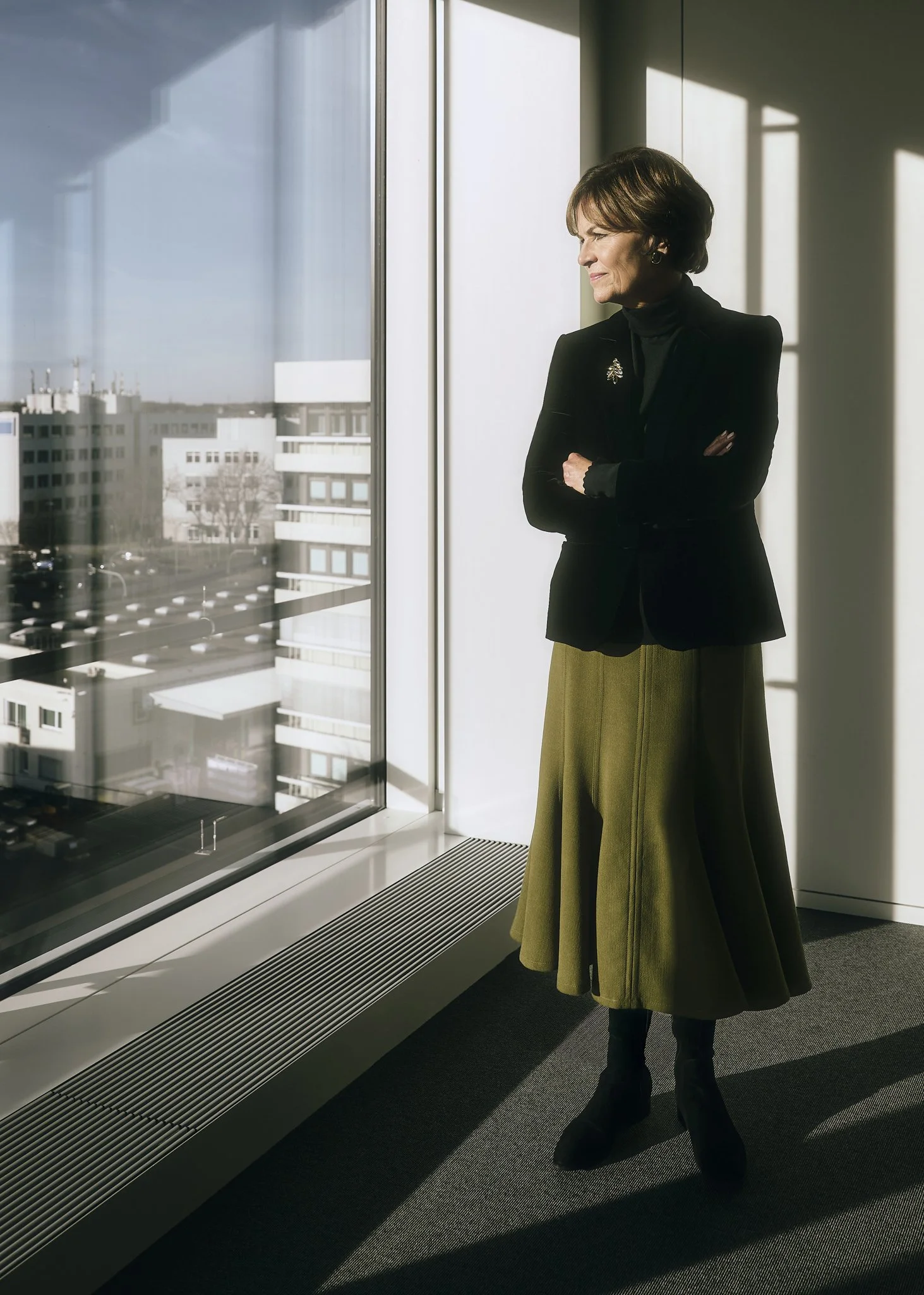 ganzkörper Business Portrait am Fenster mit Blick nach draußen, natürliche Lichtführung.