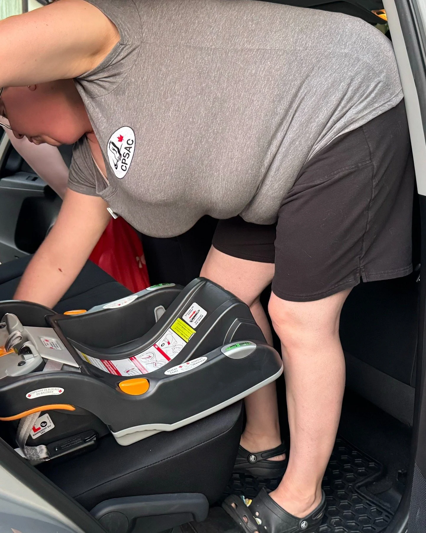 Here I am doing a car seat check. During this time I am educating parents on car seat safety and how to correctly install and use their car seat. Here I am demonstrating to the parent how to install this car seat base. After showing him, I uninstalle