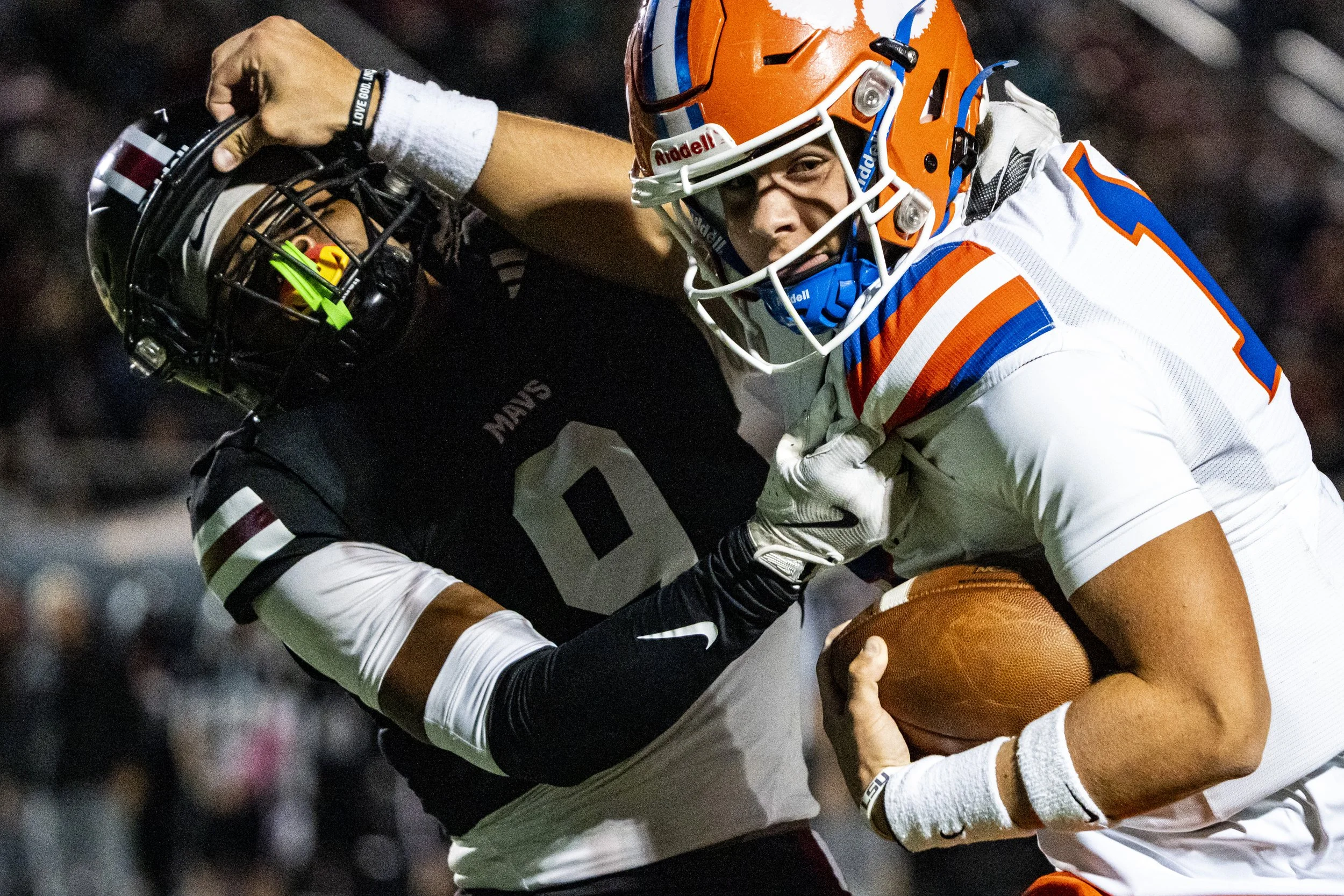 Madison Central quarterback Tripp Smith (18) stiff arms Germantown defensive back Aaron Ferrell (9) while carrying the ball during a high school football game between Madison Central and Germantown at Maverick Stadium in Madison, Miss., on Friday, Oc