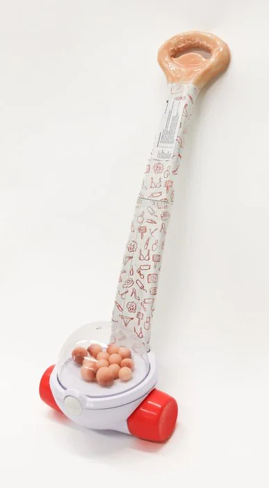 "GROSS" MOTOR SKILLS / Artist: Lainie Ettema / 20" x 18" x 14.5" / $350 / Silicone, spray paint, marker, sticker paper, popcorn popper
