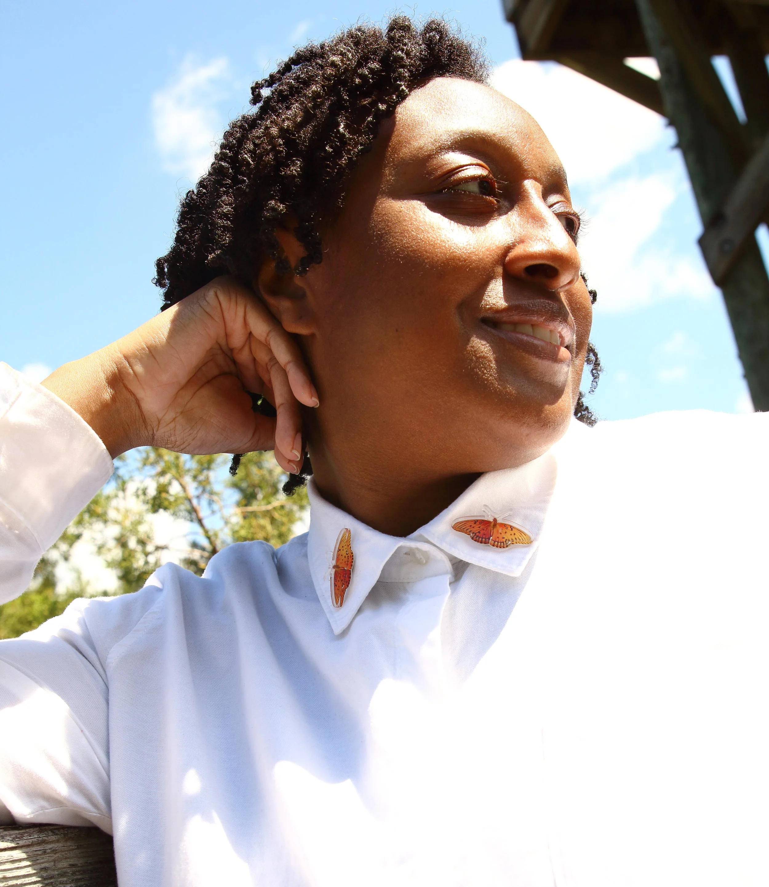 Black woman model in a white collar shirt.
