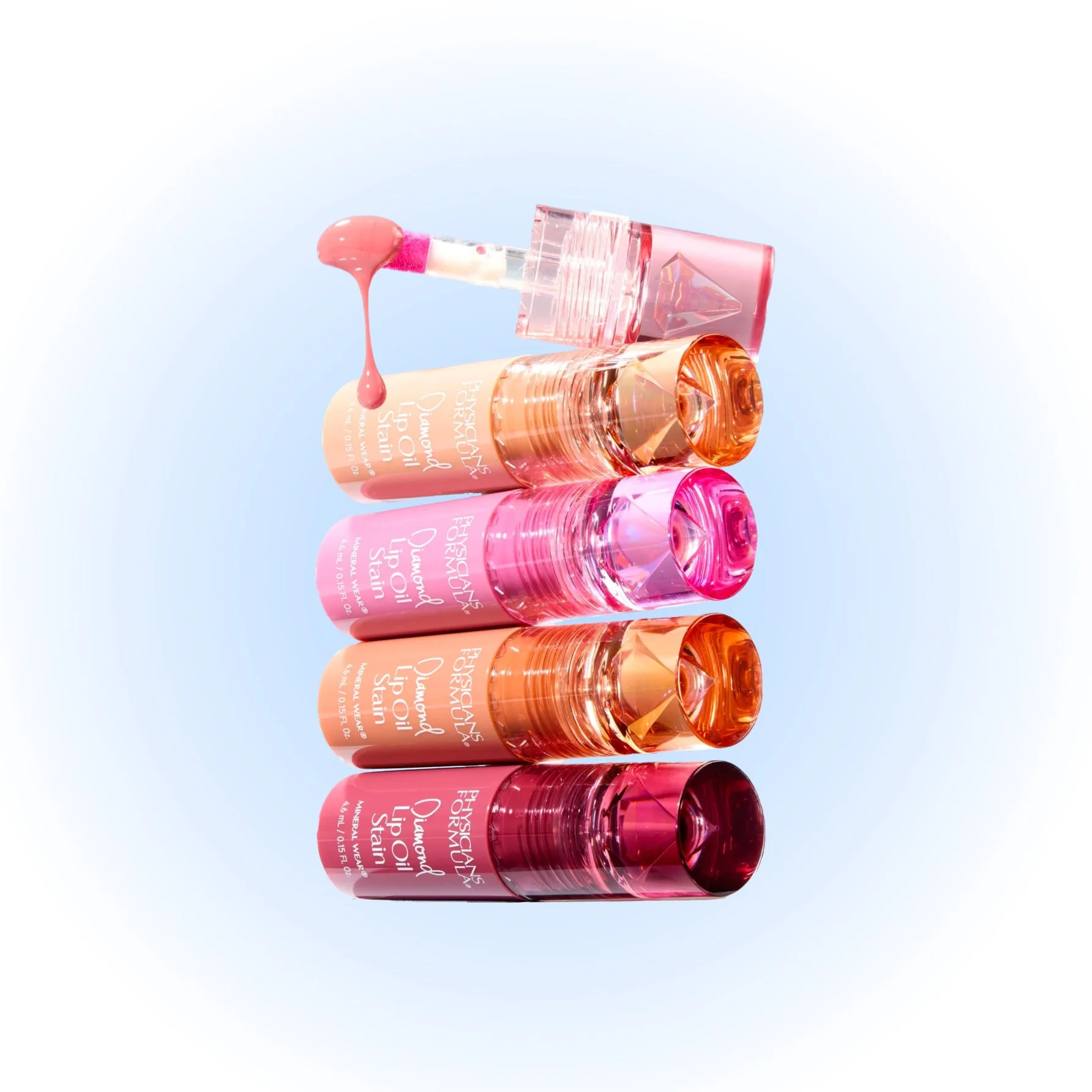 Four bottles of hydrating lip oils stacked vertically, with a dropper applying lip oil at the top, against a light blue background.