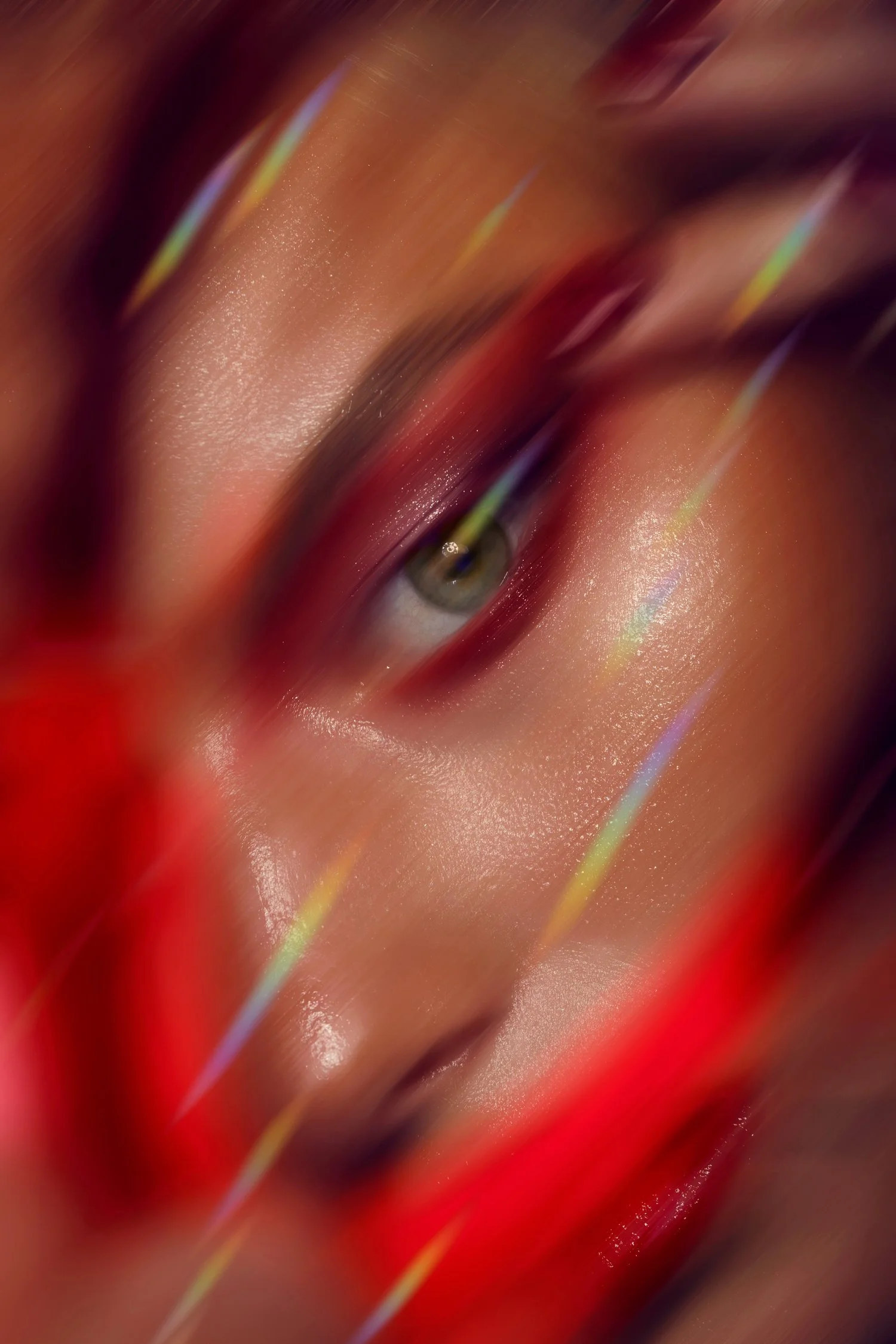 Close-up of a person's face, with makeup and colorful light reflections, partially obscured by red streaks. Beauty Photographer Los Angeles.