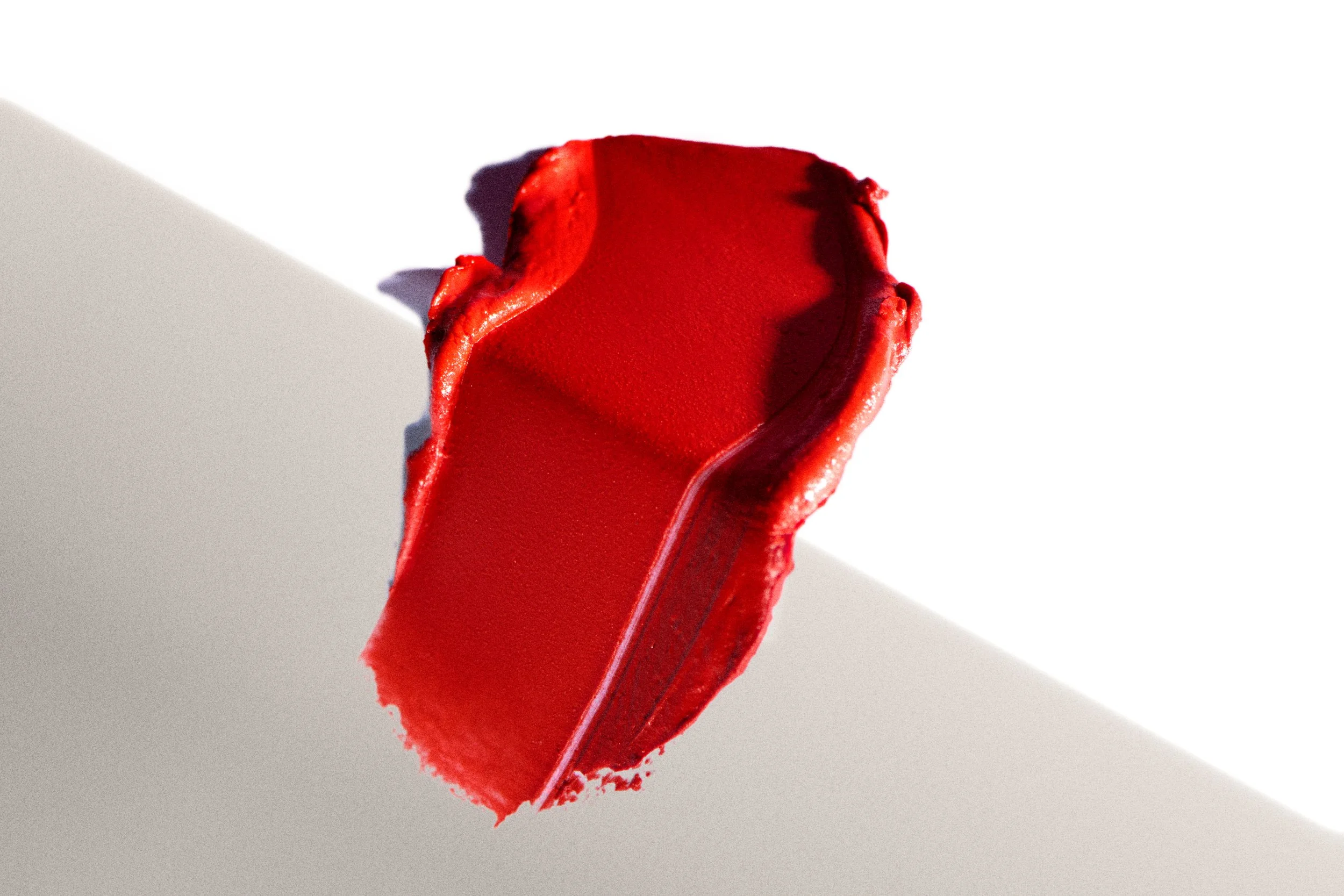 Red swatch of lipstick formula. Product photography Los Angeles.