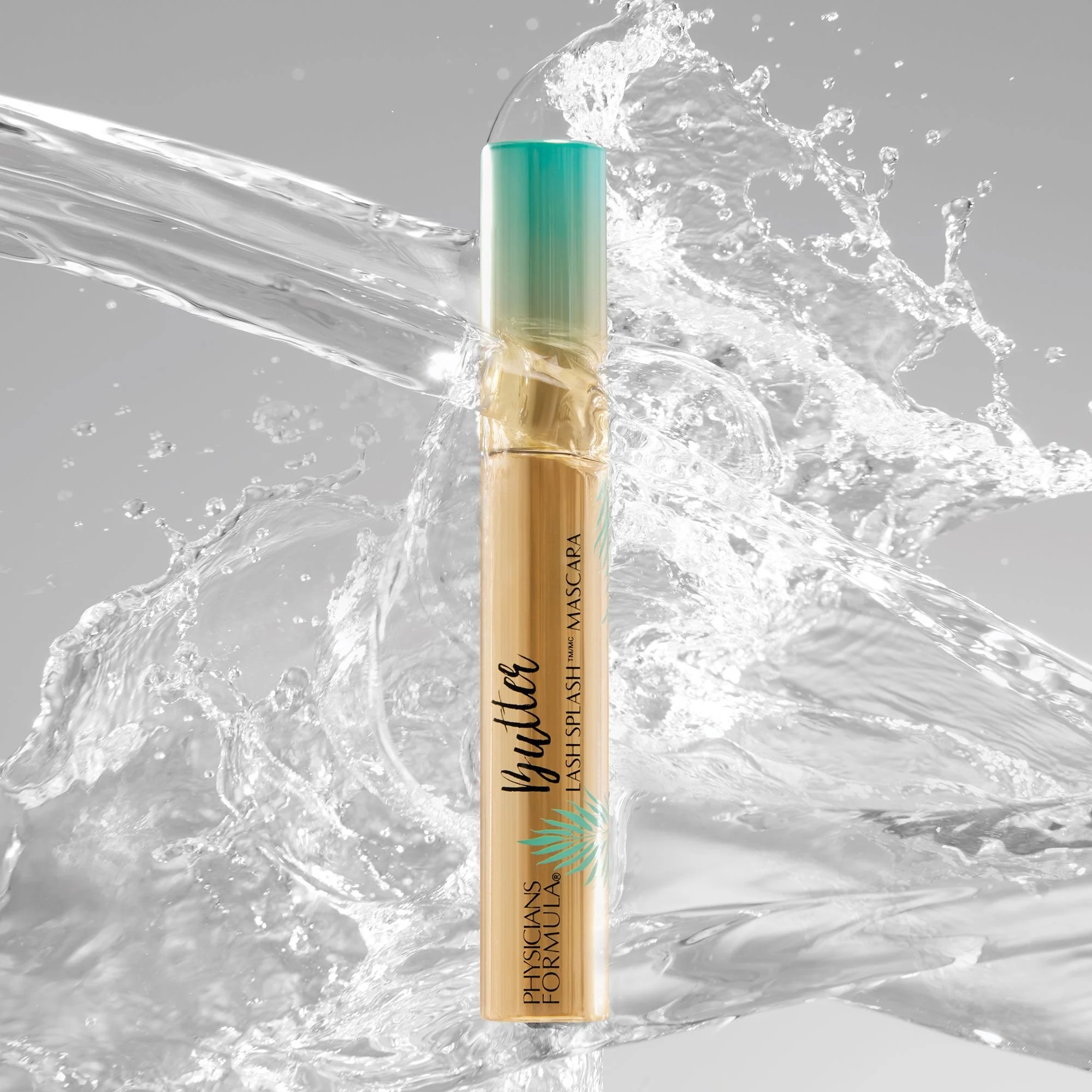 A mascara tube labeled 'Wutty Lash Splash Mascara' by Physicians Formula is surrounded by splashing water in a dynamic, high-energy shot. Product photography Los Angeles.