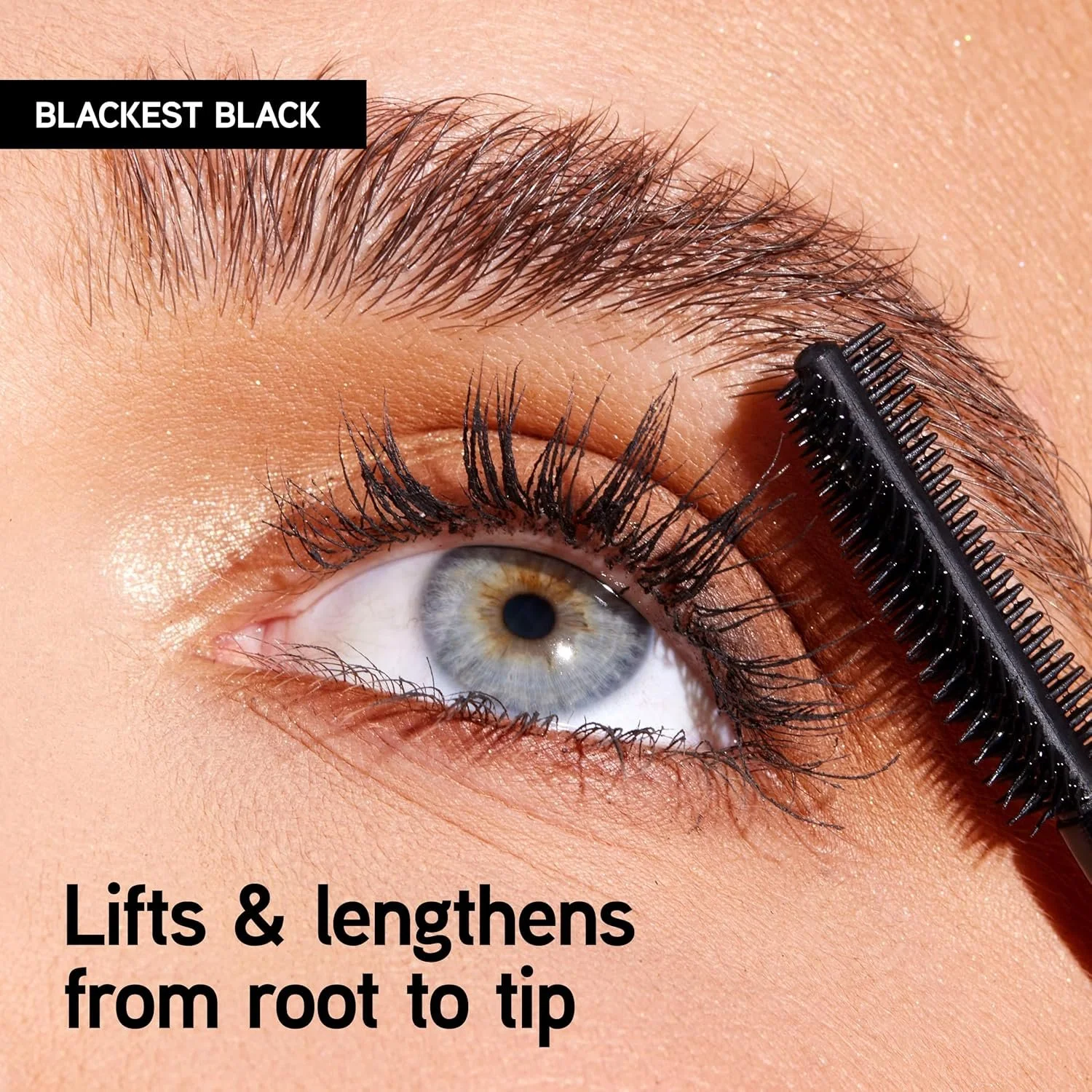 Close-up of a blue eye with mascara being combed through the eyelashes, with emphasis on eyelash lifting and lengthening, and a label indicating 'Blackest Black' mascara. Commercial Photographer Los Angeles.