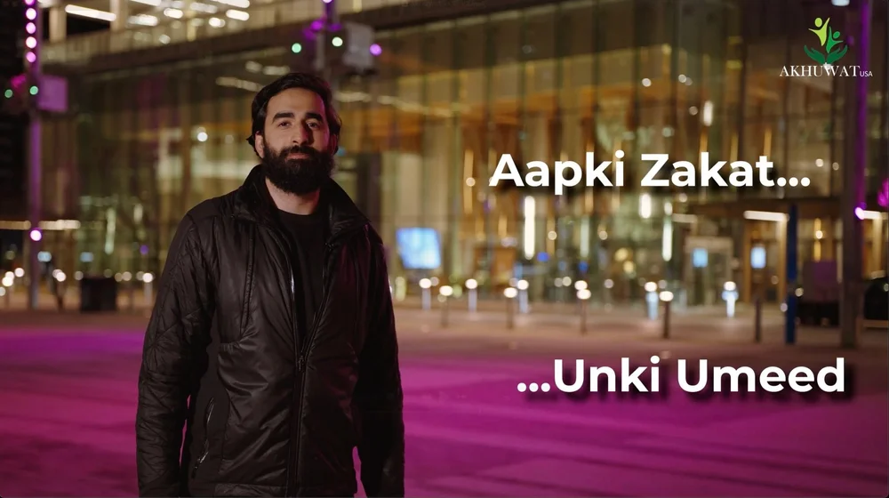 AbuBakar Khan at night beside the words Aapki Zakat, Unki Umeed, from the Akhuwat USA campaign