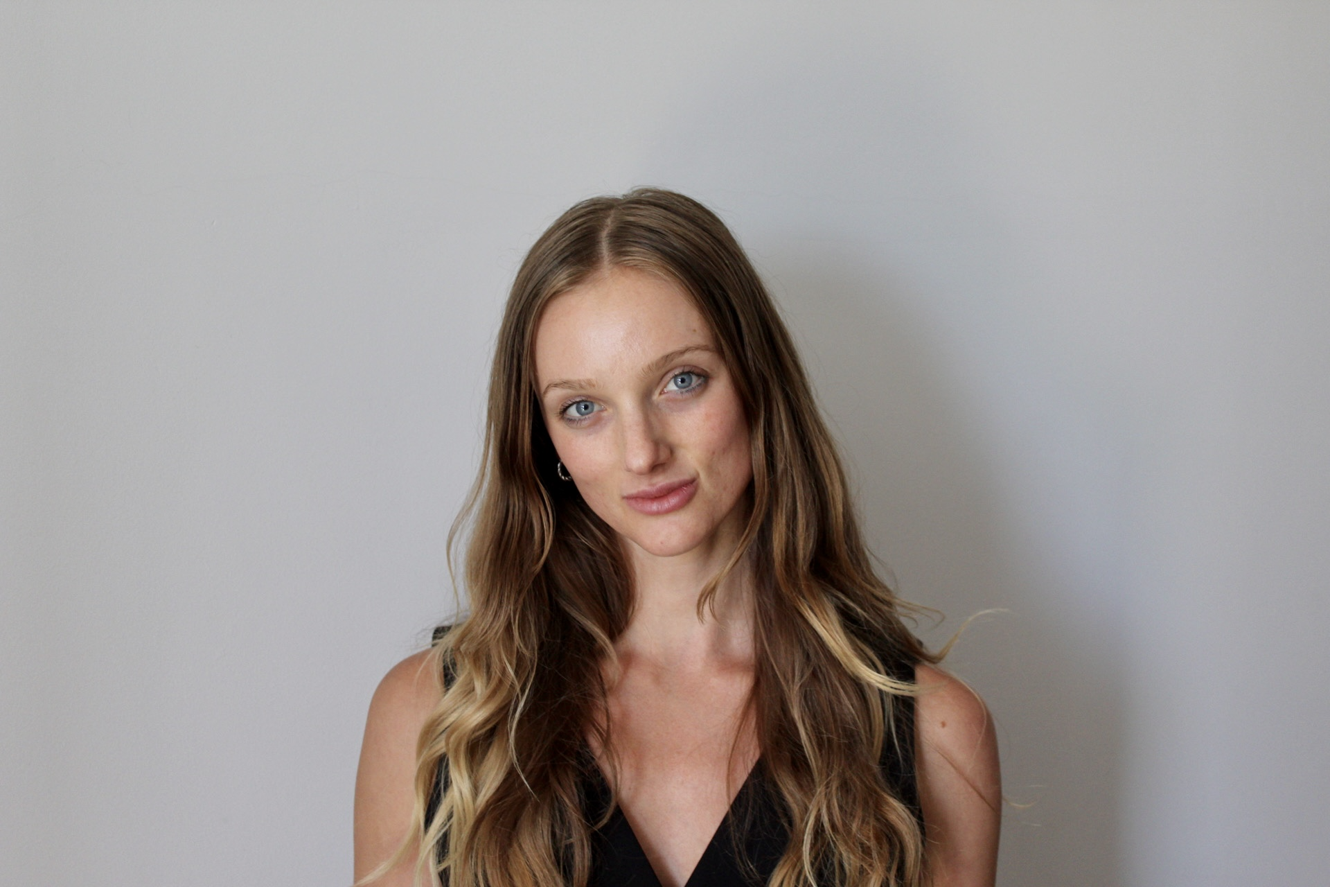 Young woman with blue eyes and long flowing brown hair