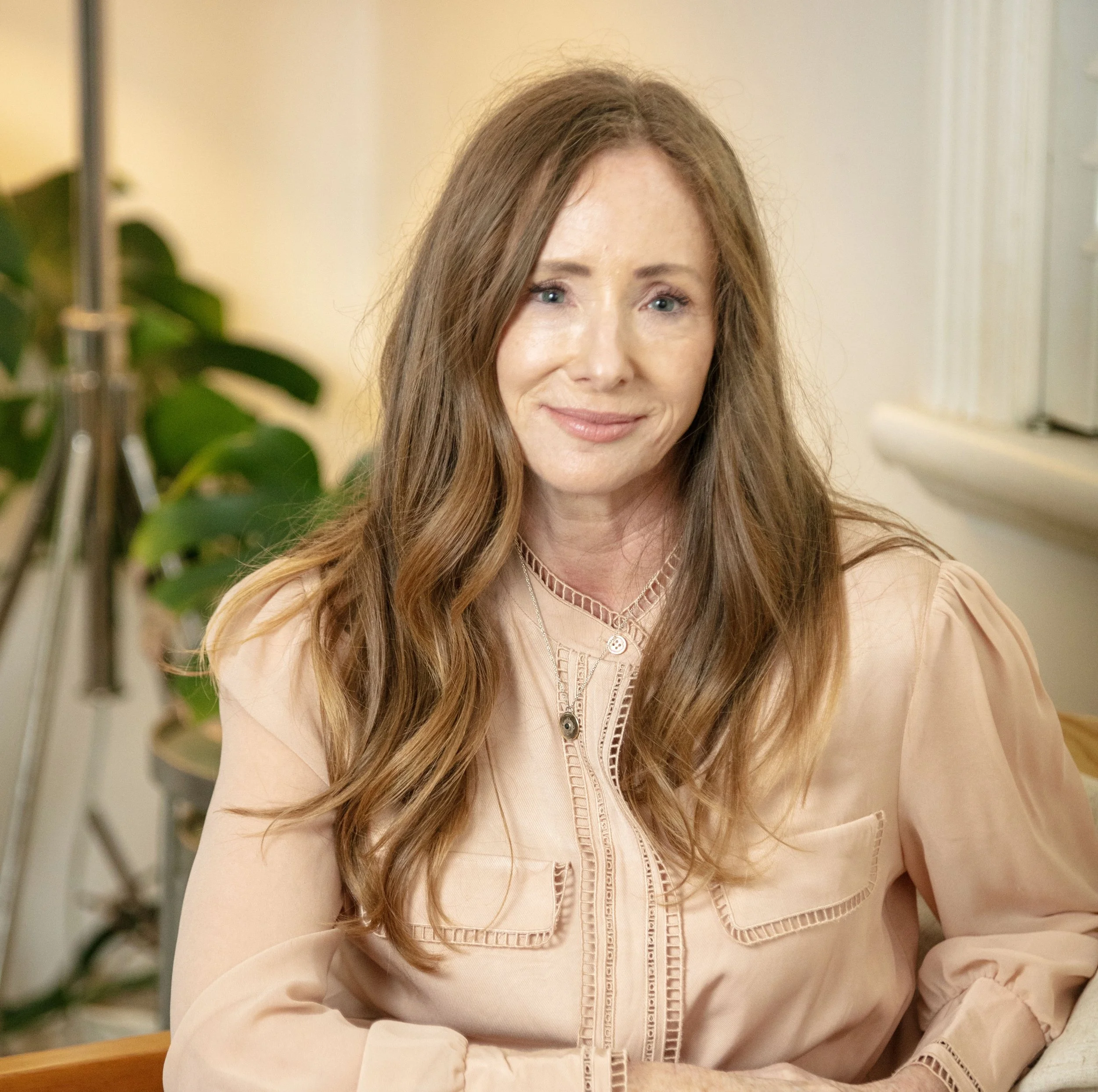 Woman with long brown hair and calming presence