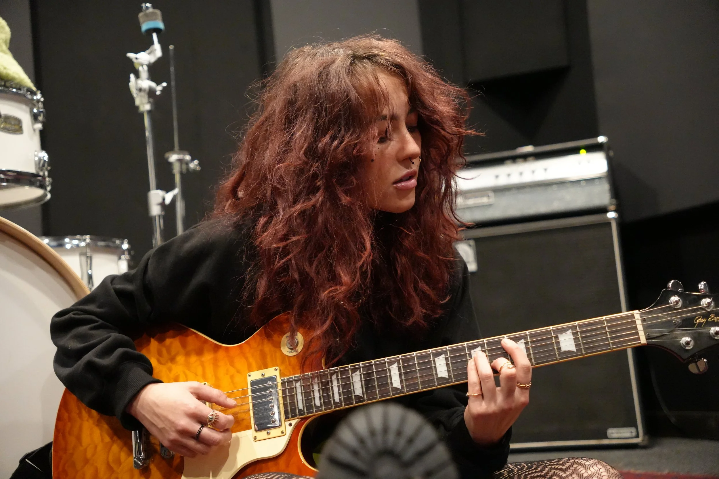 Trop Mal playing guitar during a rehearsal.