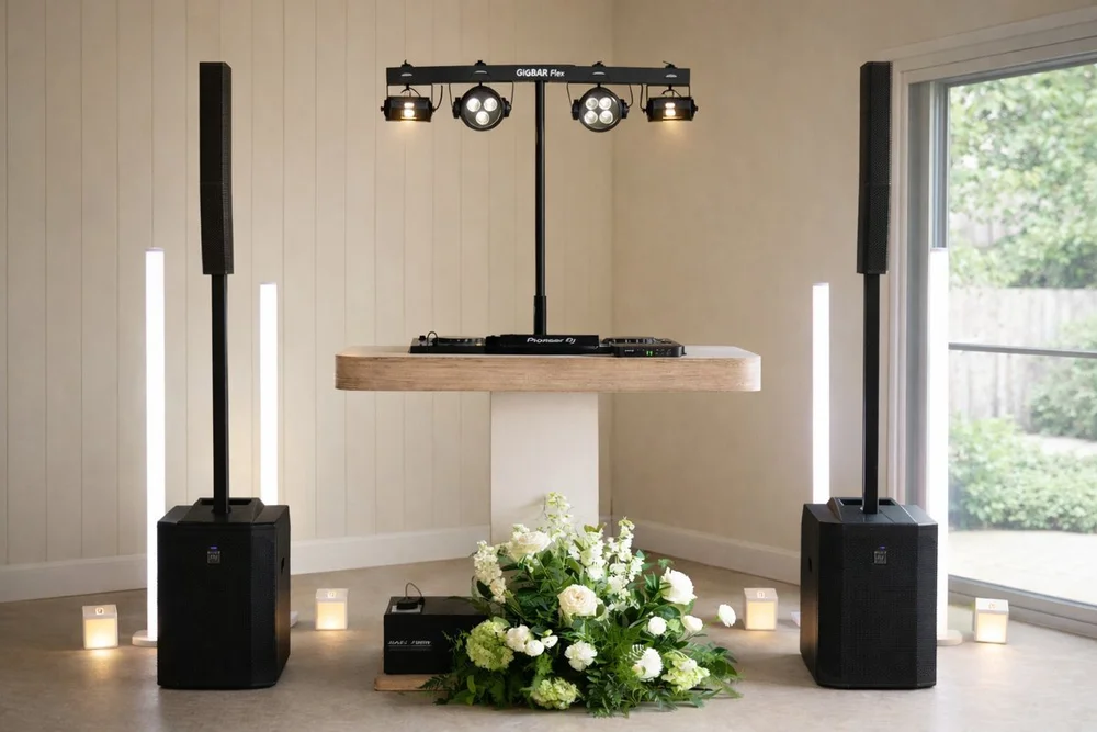 The Perfect Blend wedding DJ and MC setup with custom timber DJ booth, column speakers and GigBar Flex lighting