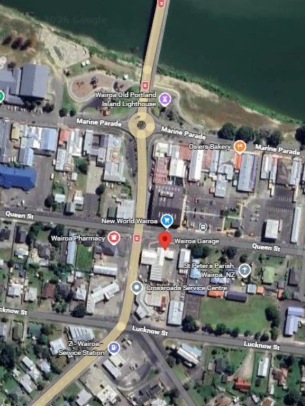 Satellite map of Wairua, New Zealand showing streets, buildings, the waterfront, and landmarks such as Wairua Old Portland Island Lighthouse, Wairua Pharmacy, Wairua Garage, and St Peter's Parish.