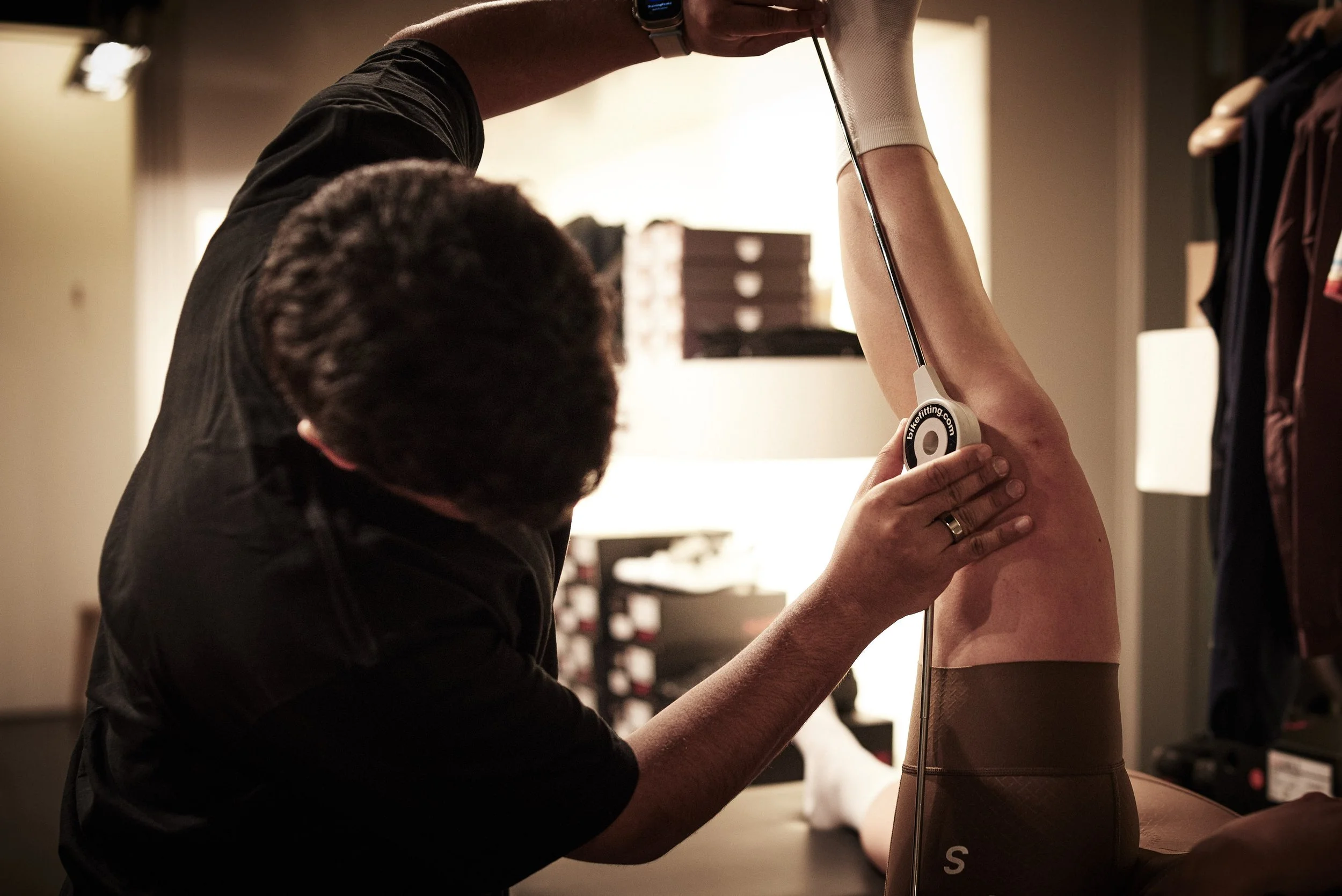 A person receiving an ultrasound on their leg from a healthcare professional in a clinical setting.