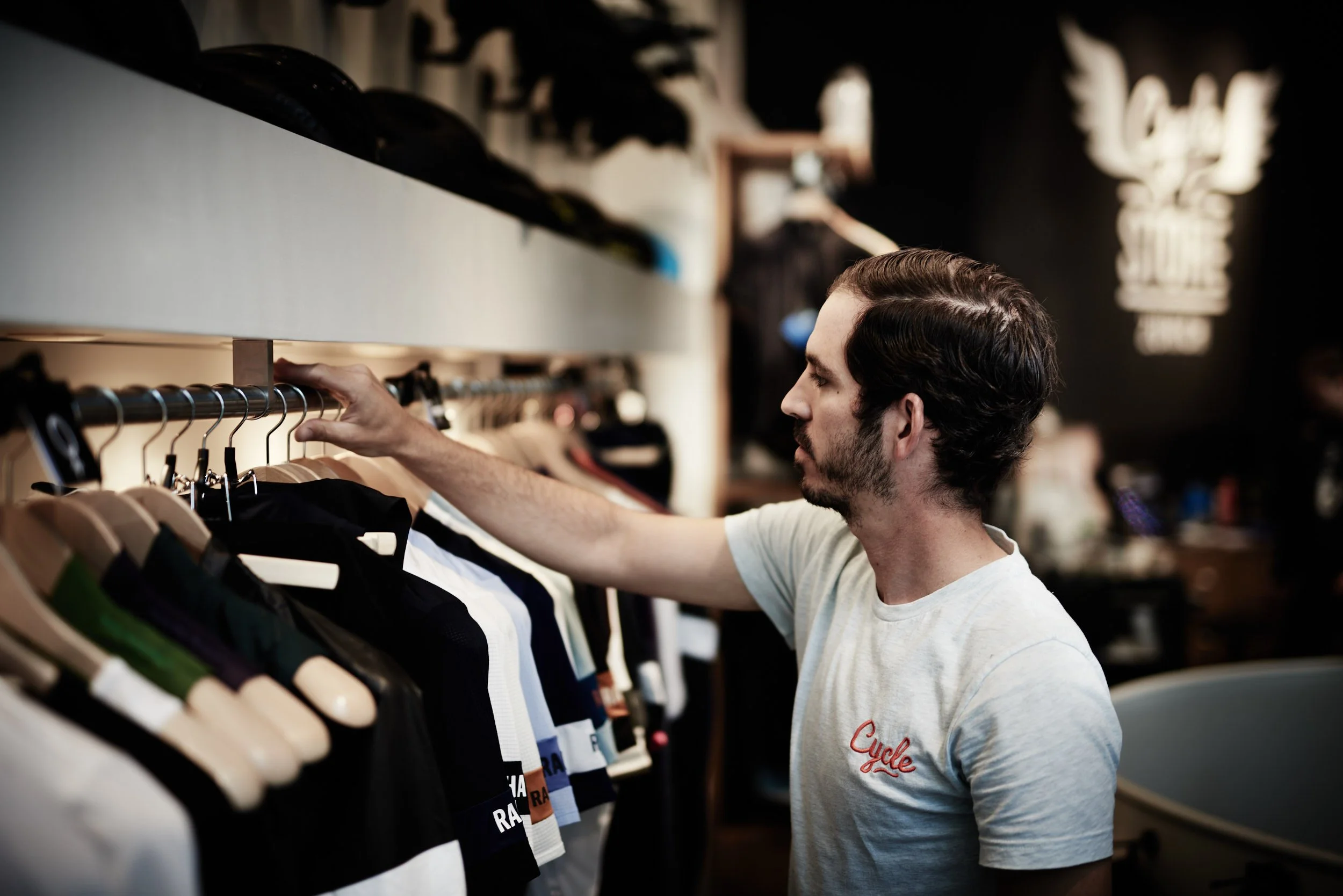 Man shopping for cycling jerseys in a store