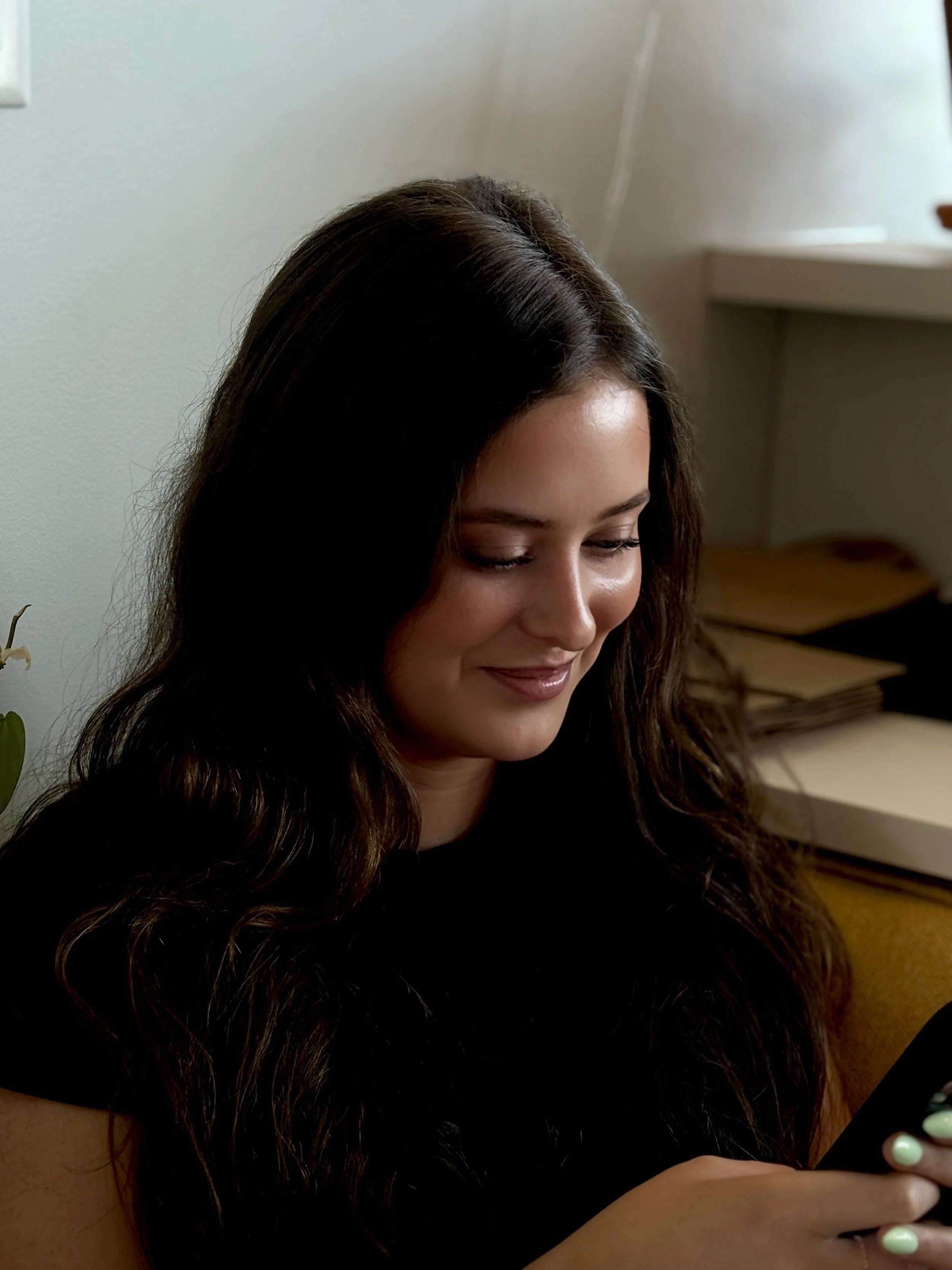 BRUNETTE, LOOKING DOWN, SOFT SMILE