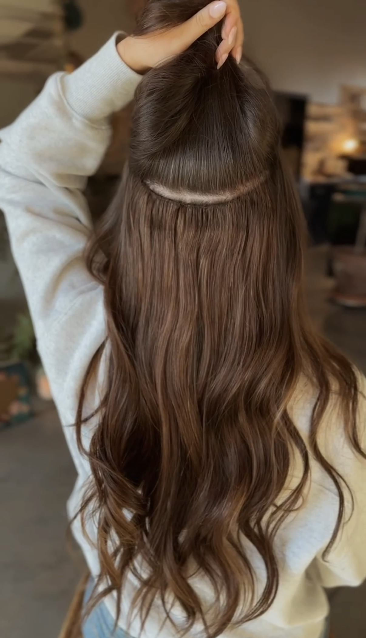 Sewn-In hair extensions on long brunette hair.