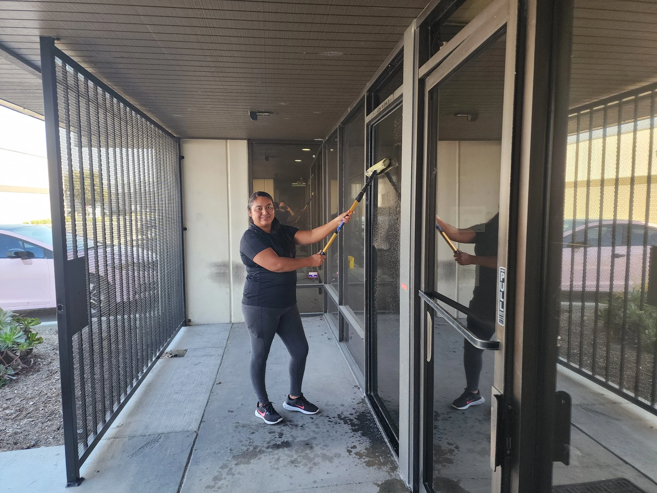 Commercial real estate cleaning services in Anaheim CA cleaning exterior glass walls of a commercial unit