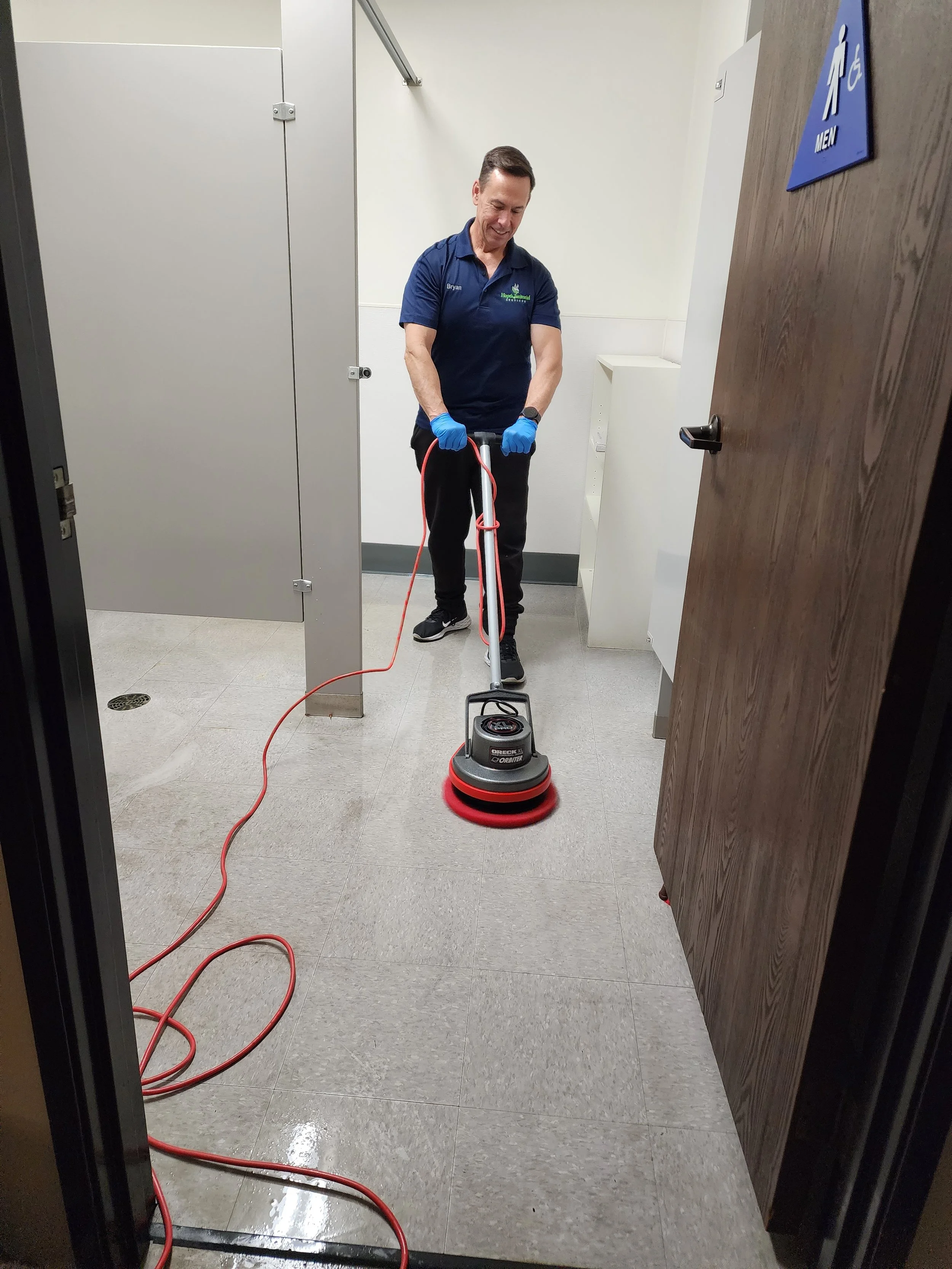 Floor scrubbing by commercial real estate cleaning services for an Orange County property