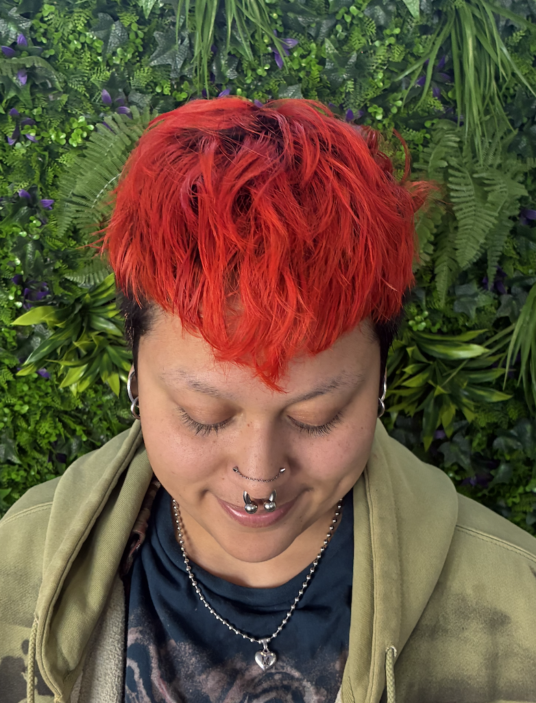 Red-orange vivid as roots grow out and v-bangs