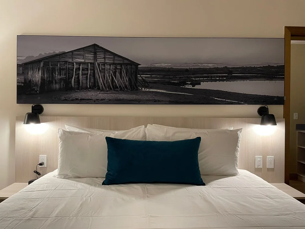 Guestroom with upholstered bed and wall artwork at Wyndham Garden El Morro
