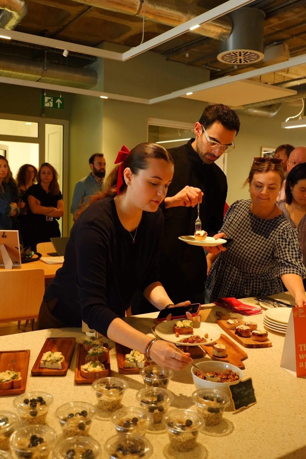 Colleagues serving themselves small plates at a lunch and learn tasting table