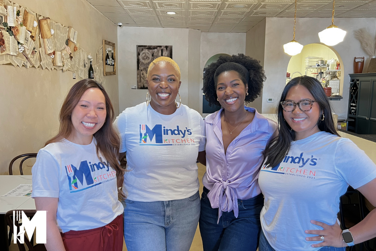 Four ladies posing side to side with smiles on their faces