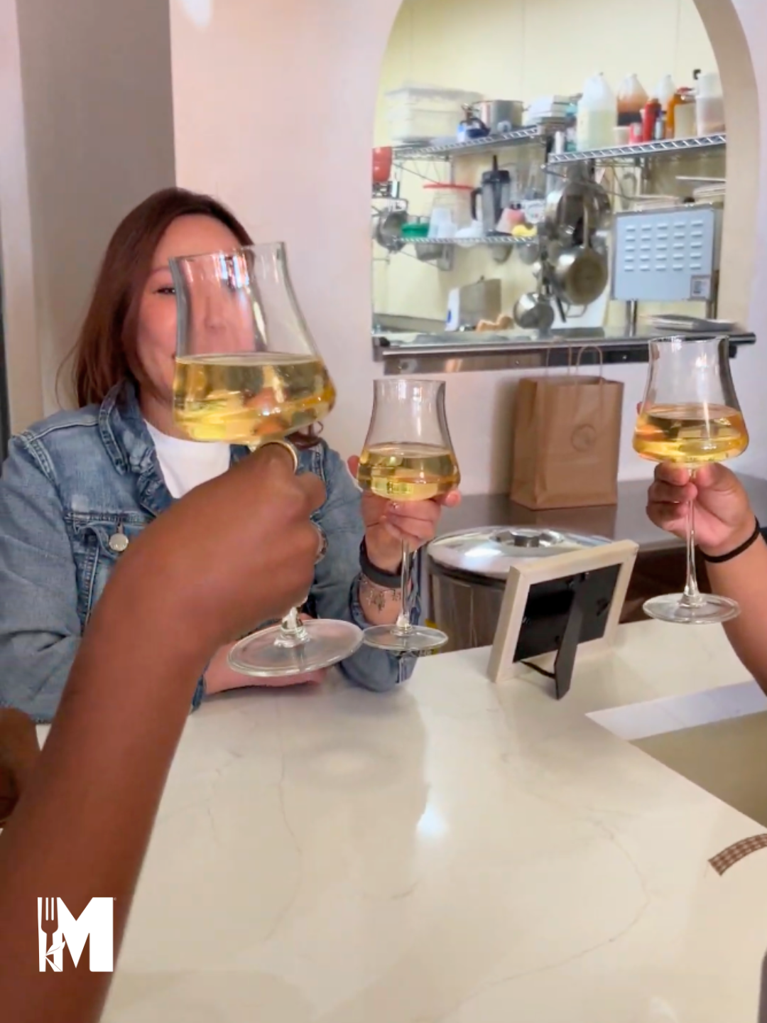 Image of hands holding wine glasses in a "cheers" position