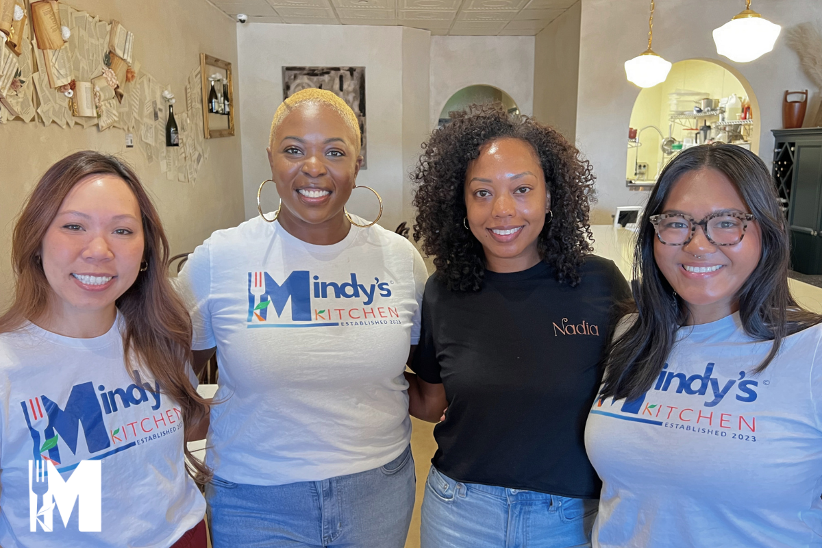 four ladies standing next to each other smiling for the camera