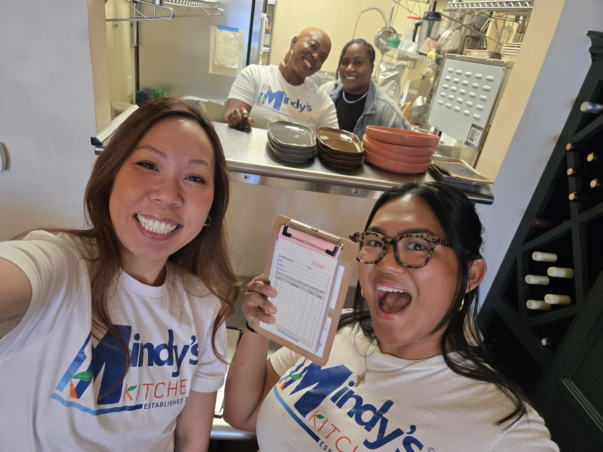 4 ladies taking a self wearing the Mindy's Kitchen branded shirts