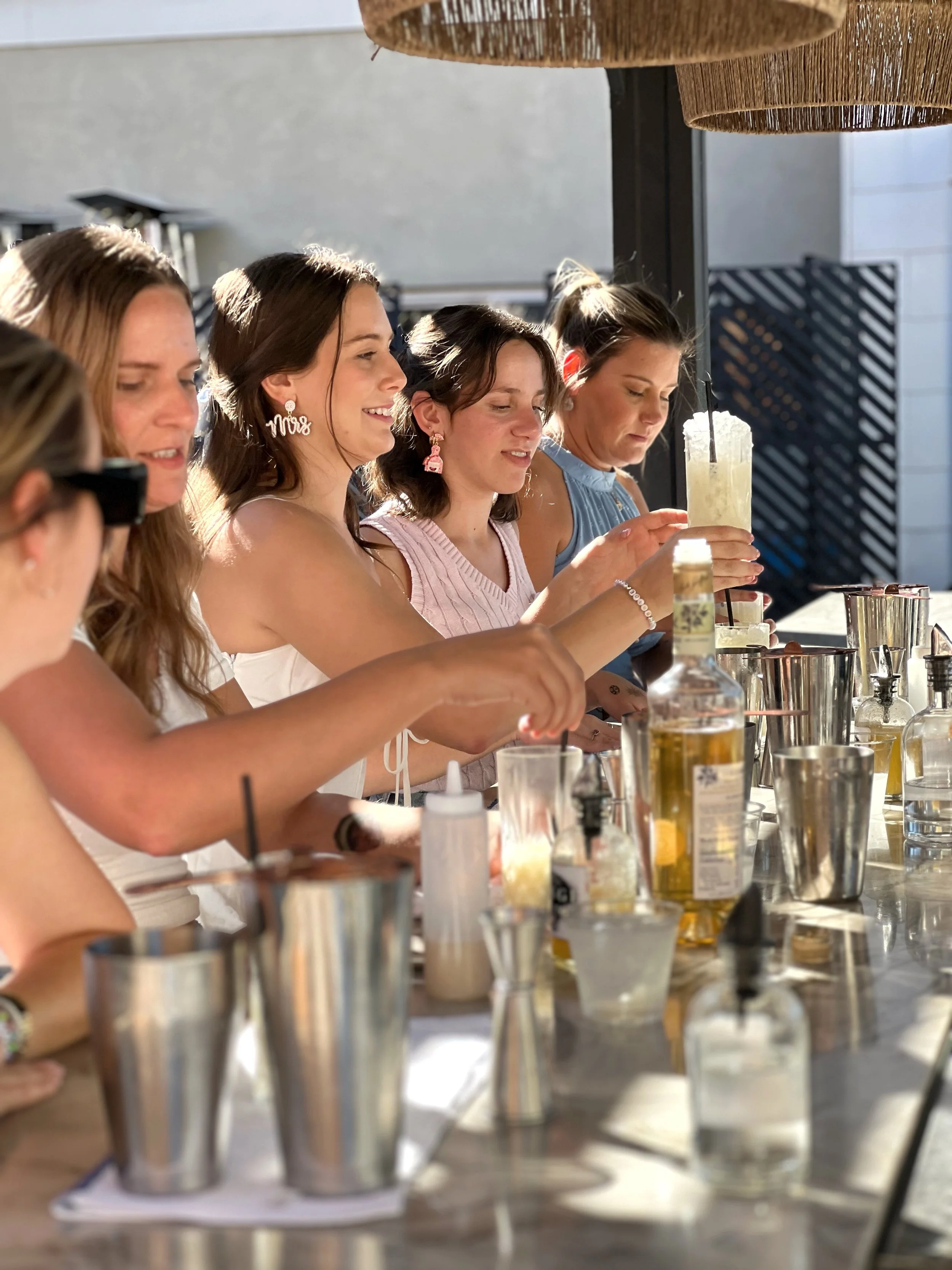 Guests participating in Vici Rooftop's hands-on mixology class, learning to craft elevated cocktails on Savannah's rooftop bar.