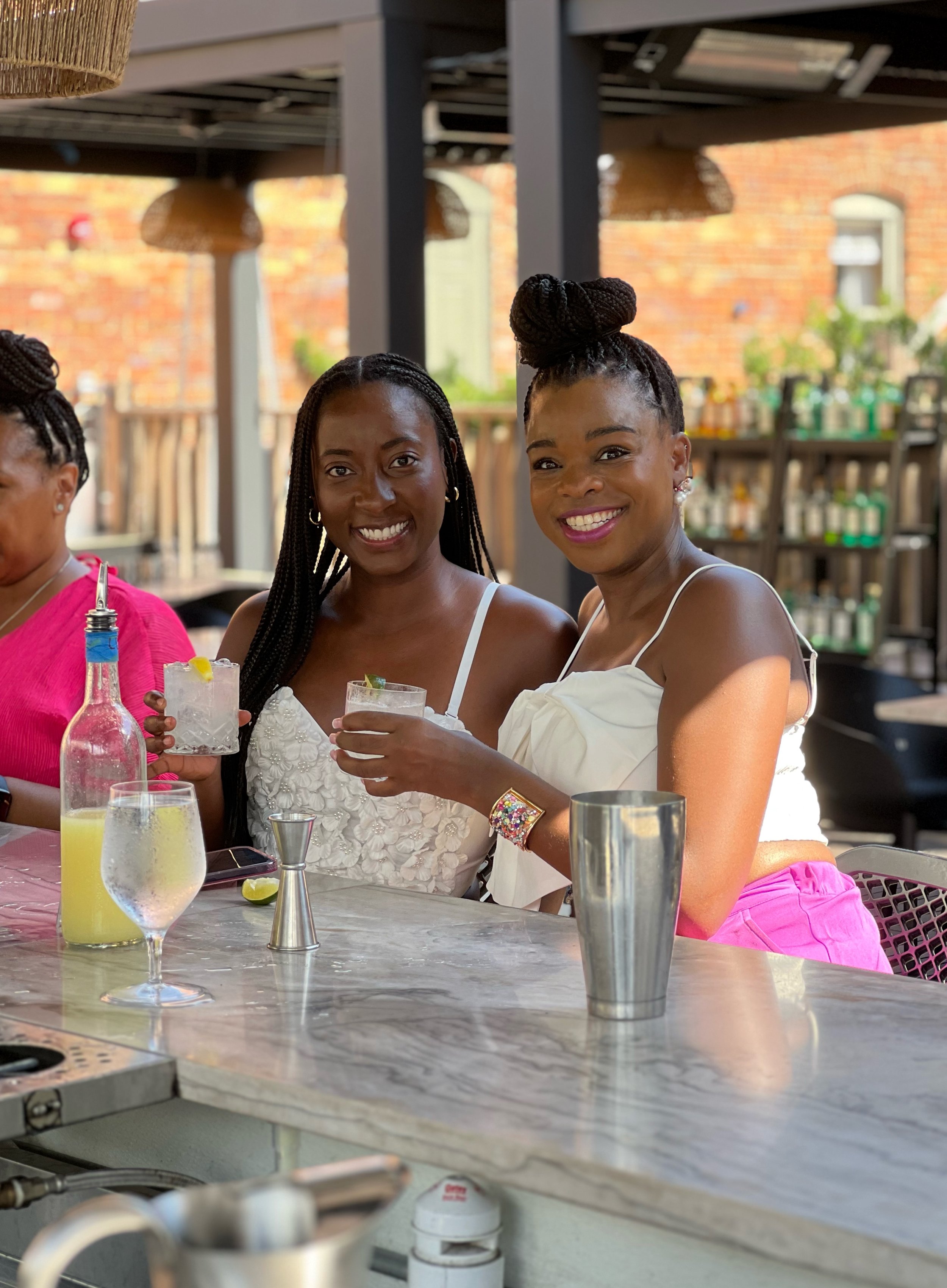 Group of women enjoying a rooftop Mixology class at Vici Rooftop in Savannah, shaking cocktails together during a hands-on experience