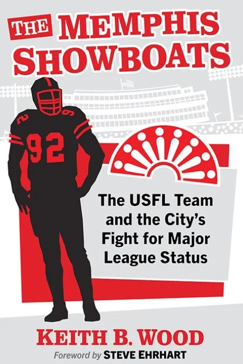 Cover of a book titled 'The Memphis Showboats: The USFL Team and the City's Fight for Major League Status' by Keith B. Wood, with a foreword by Steve Ehrhart. The cover features a black silhouette of a football player wearing a helmet with the number 92 and a fan-shaped graphic and a partly visible stadium in the background.