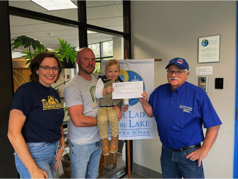 Rick and Judy presented the check to Ben Colianni and his son Ben.