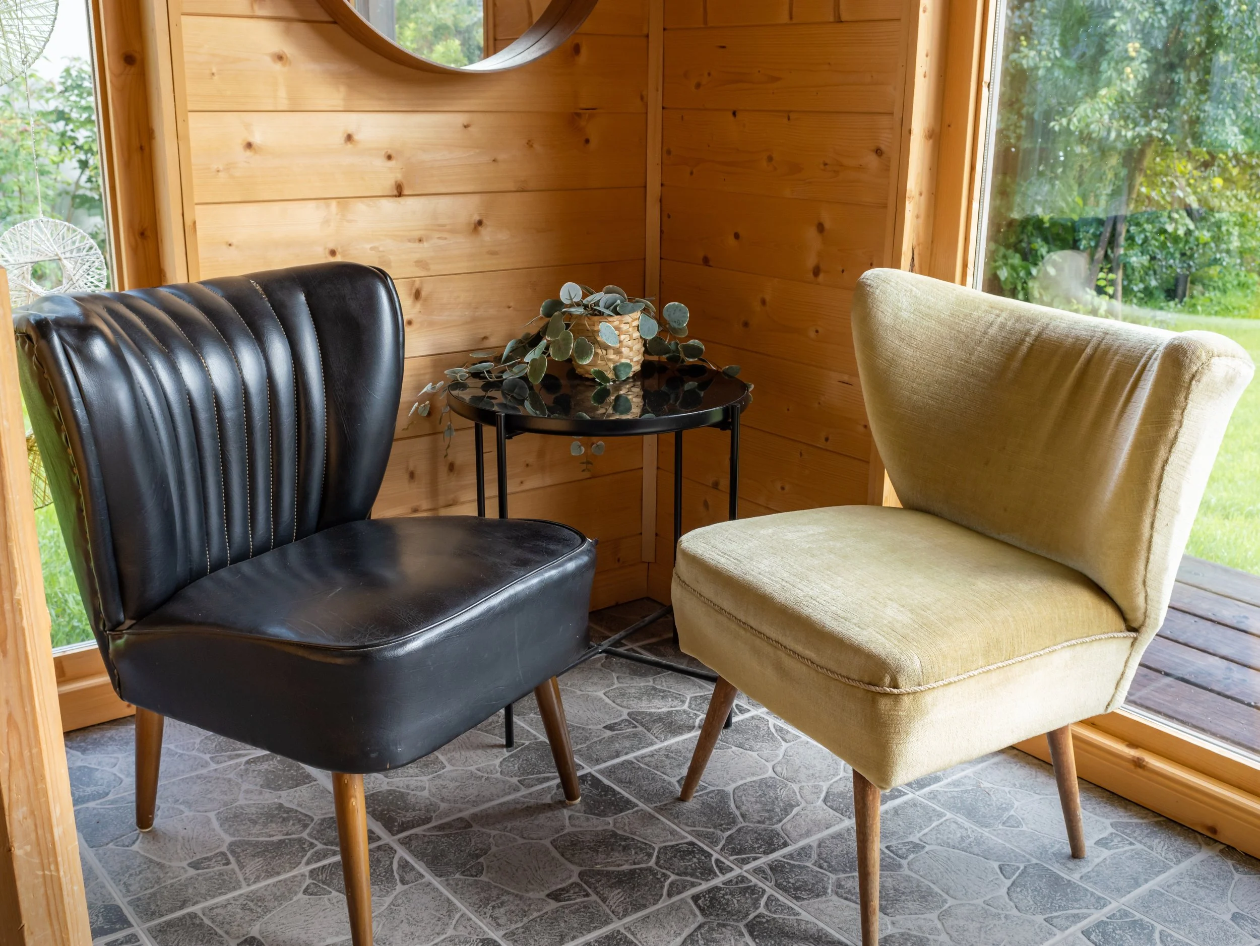 Two different chairs facing one another in a warm, quiet space, symbolizing conversation and connection.