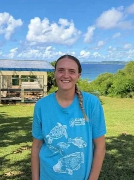 GCRI staff member smiles with greenery and the ocean in the background