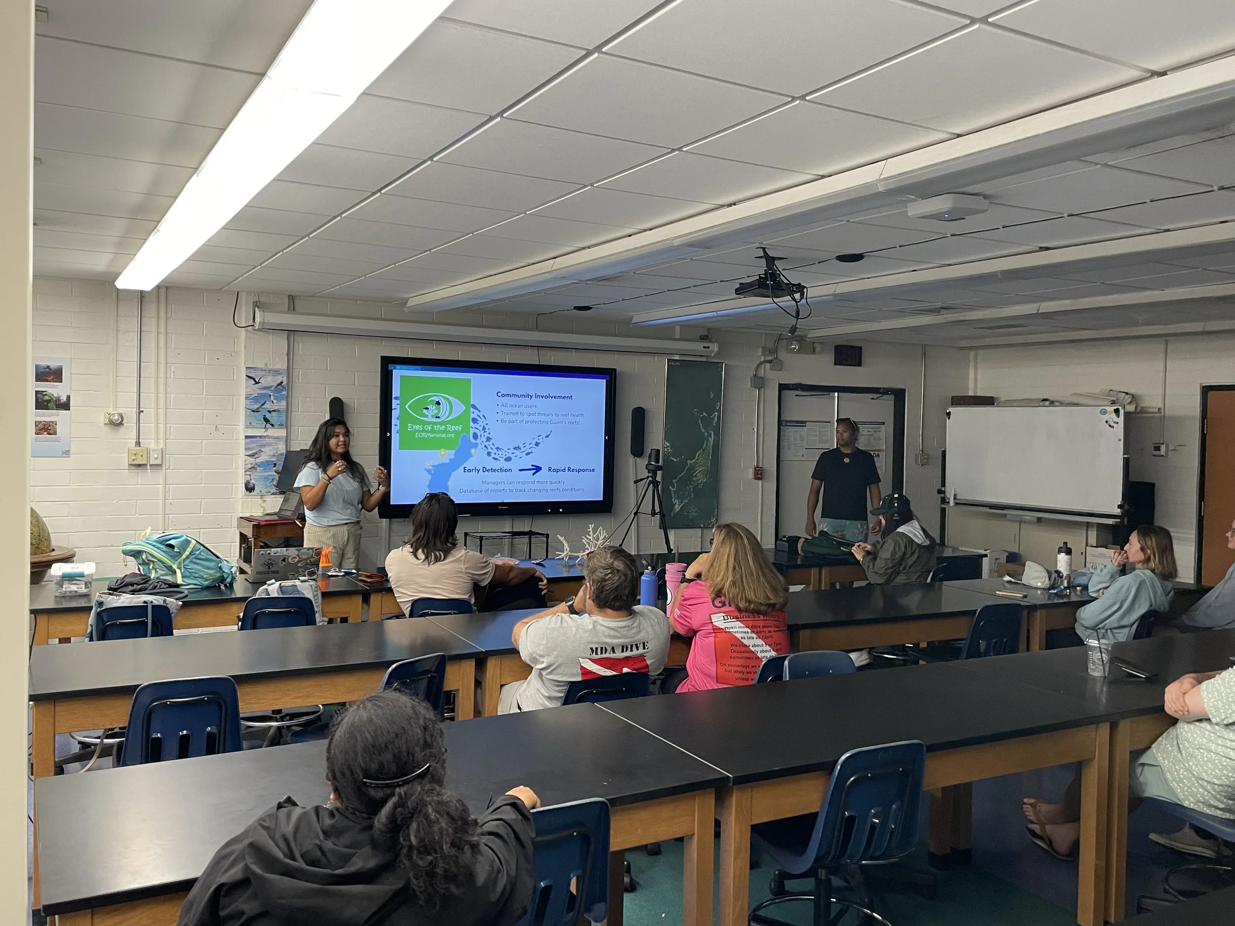Female staff member presenting to a classroom of adults about GCRI's Eyes of the Reef program