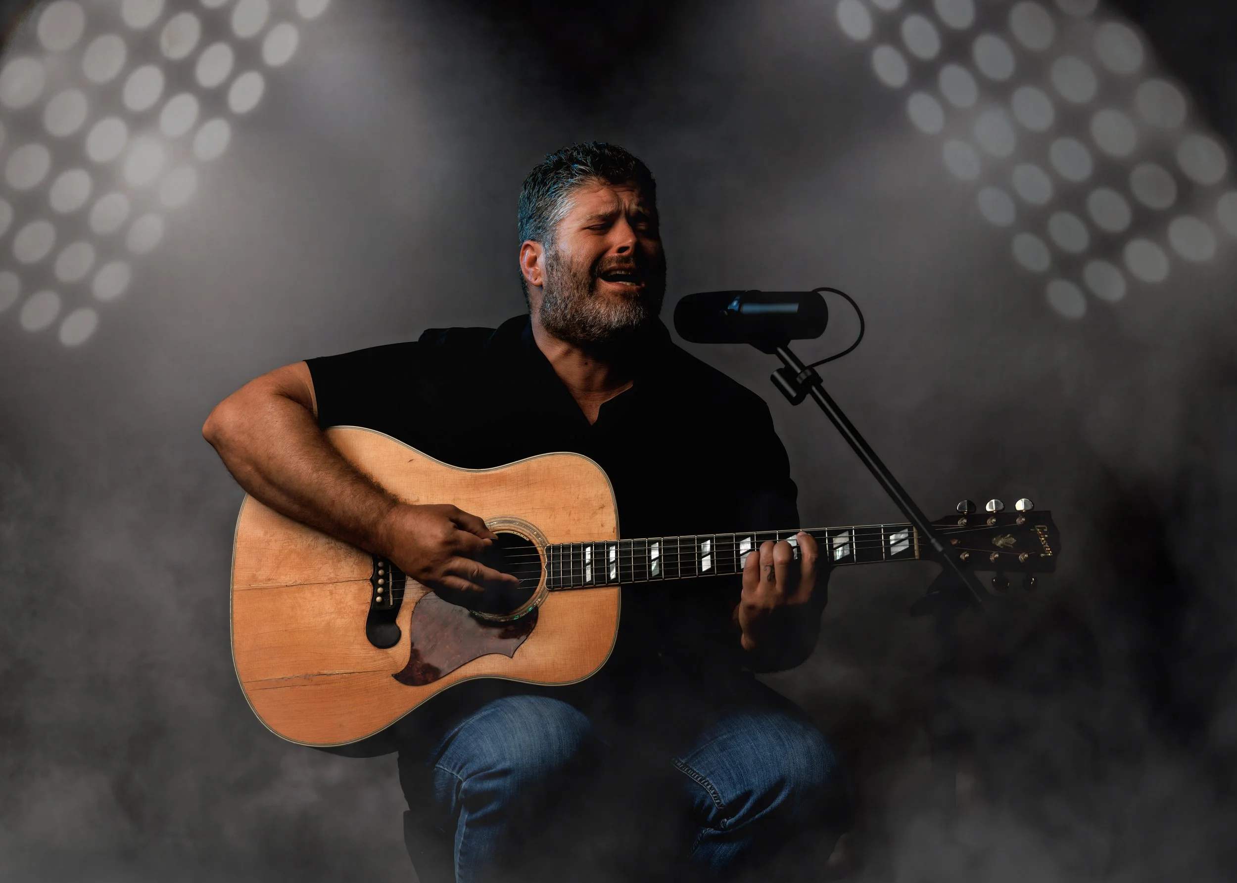 Musician on stage playing guitar studio branding image 