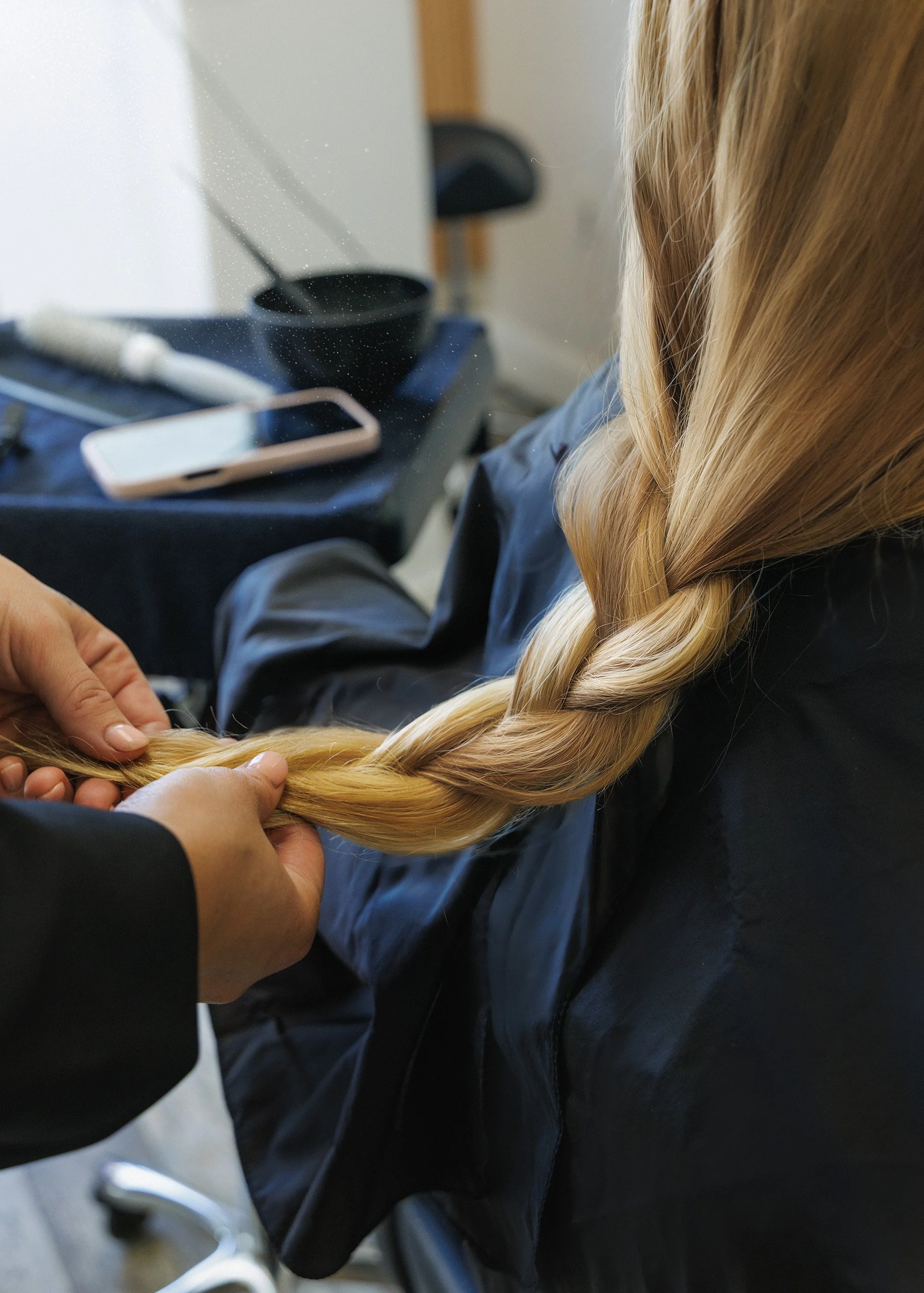 Branding photography stylist working on hair in a salon