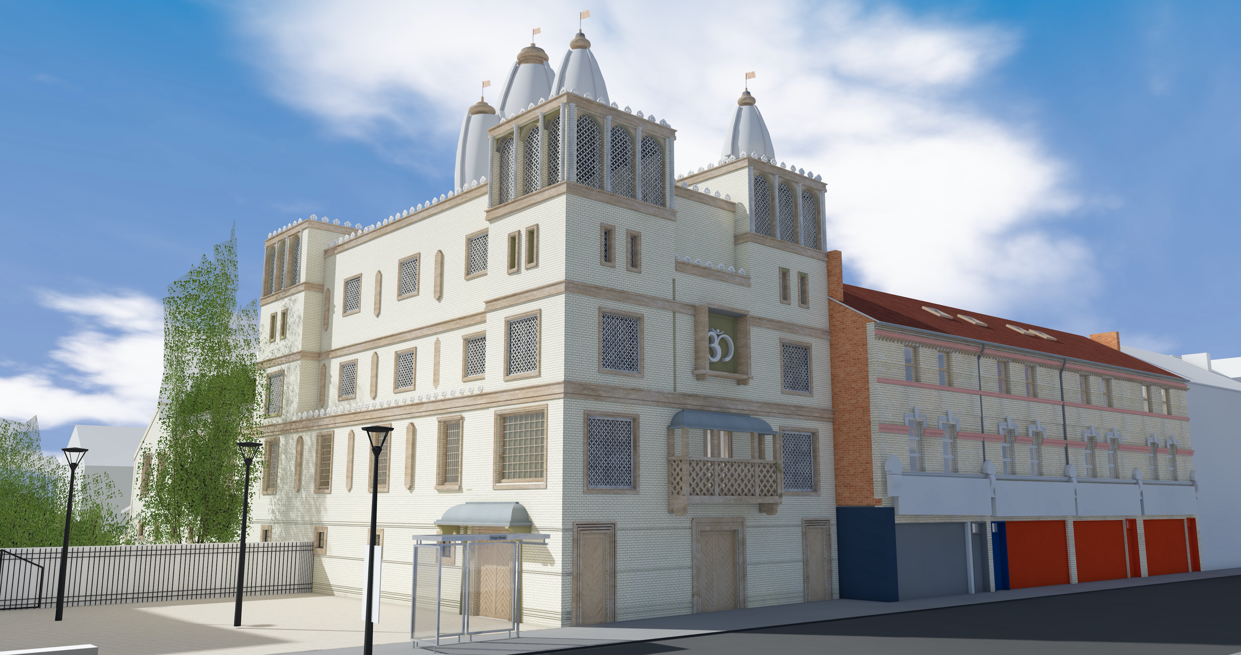 A large, historic multi-story building with medieval architectural design, featuring pointed towers with flags on top, many windows with decorative grilles, and a mix of brick and brick-like exterior walls, set against a blue sky with scattered cloud