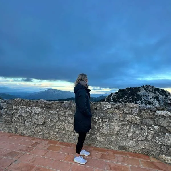 midlife woman looking out at scenery from an Athara tour