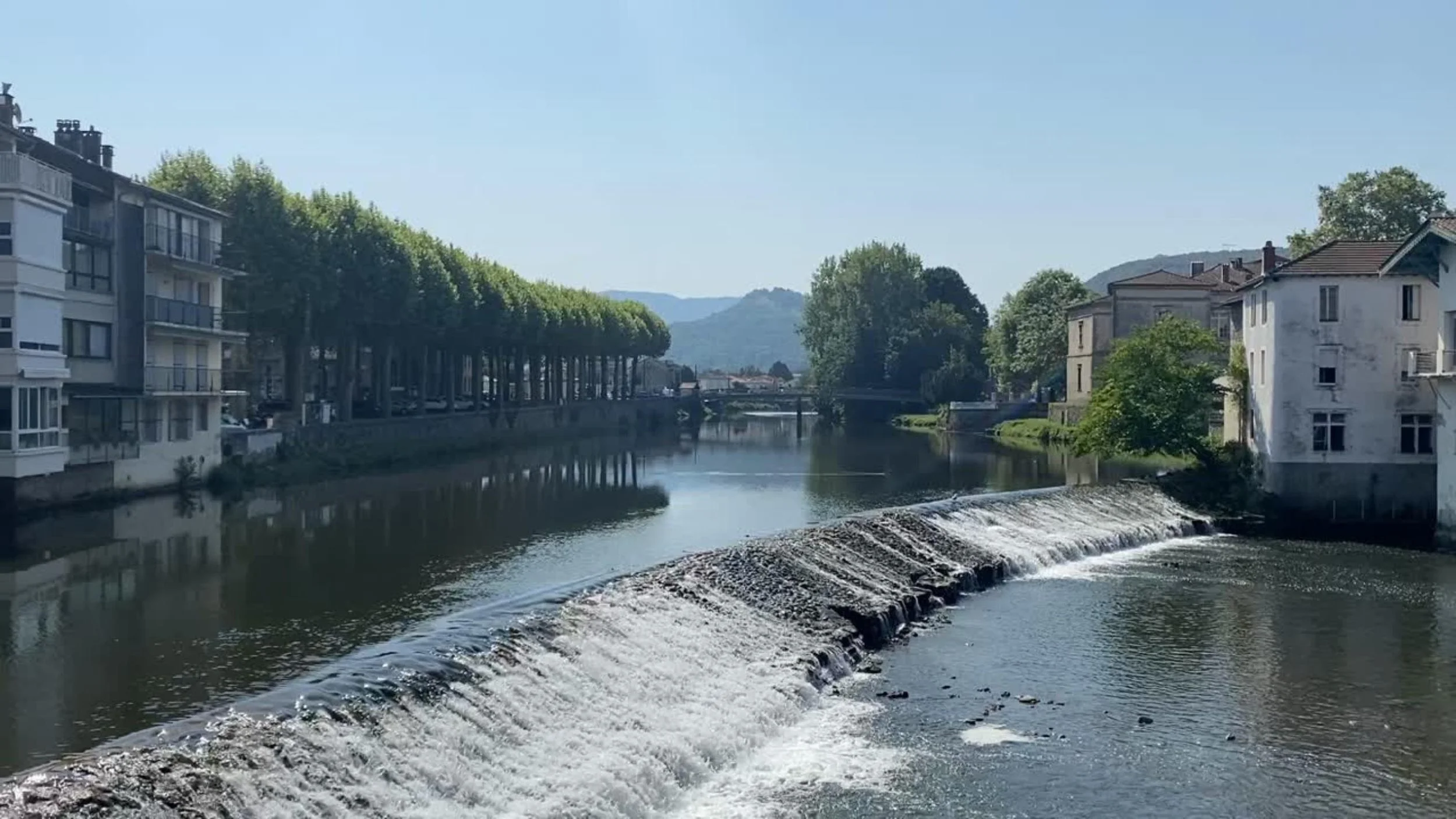River running through Saint-girons, France on a sunny day.